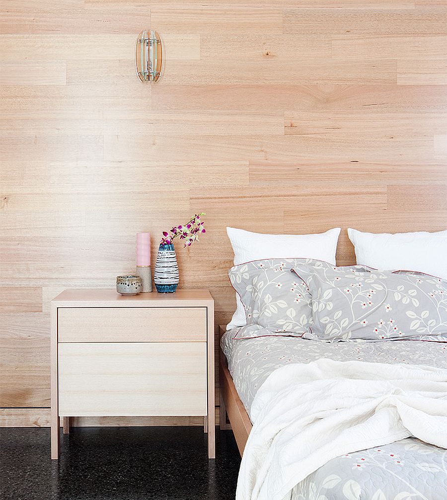 Wooden walls in the bedroom gives it a cozy and comfortable visual appeal