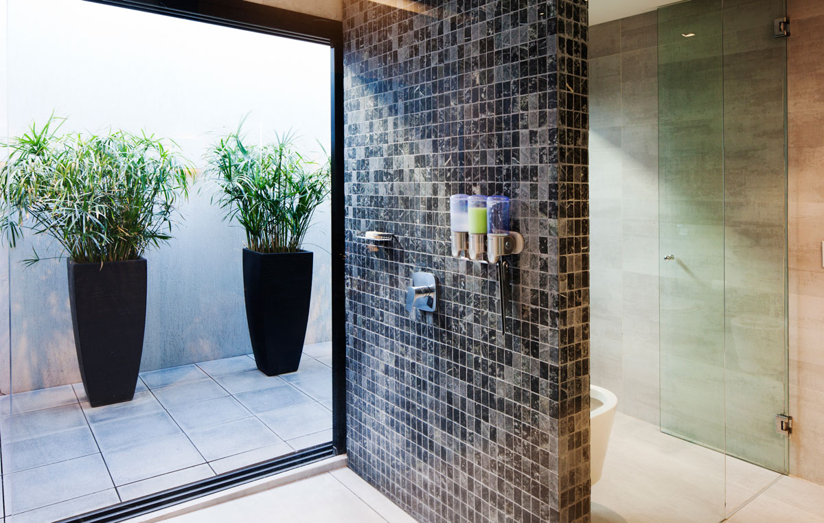 Bathroom on the upper level of the house with a stone shower area