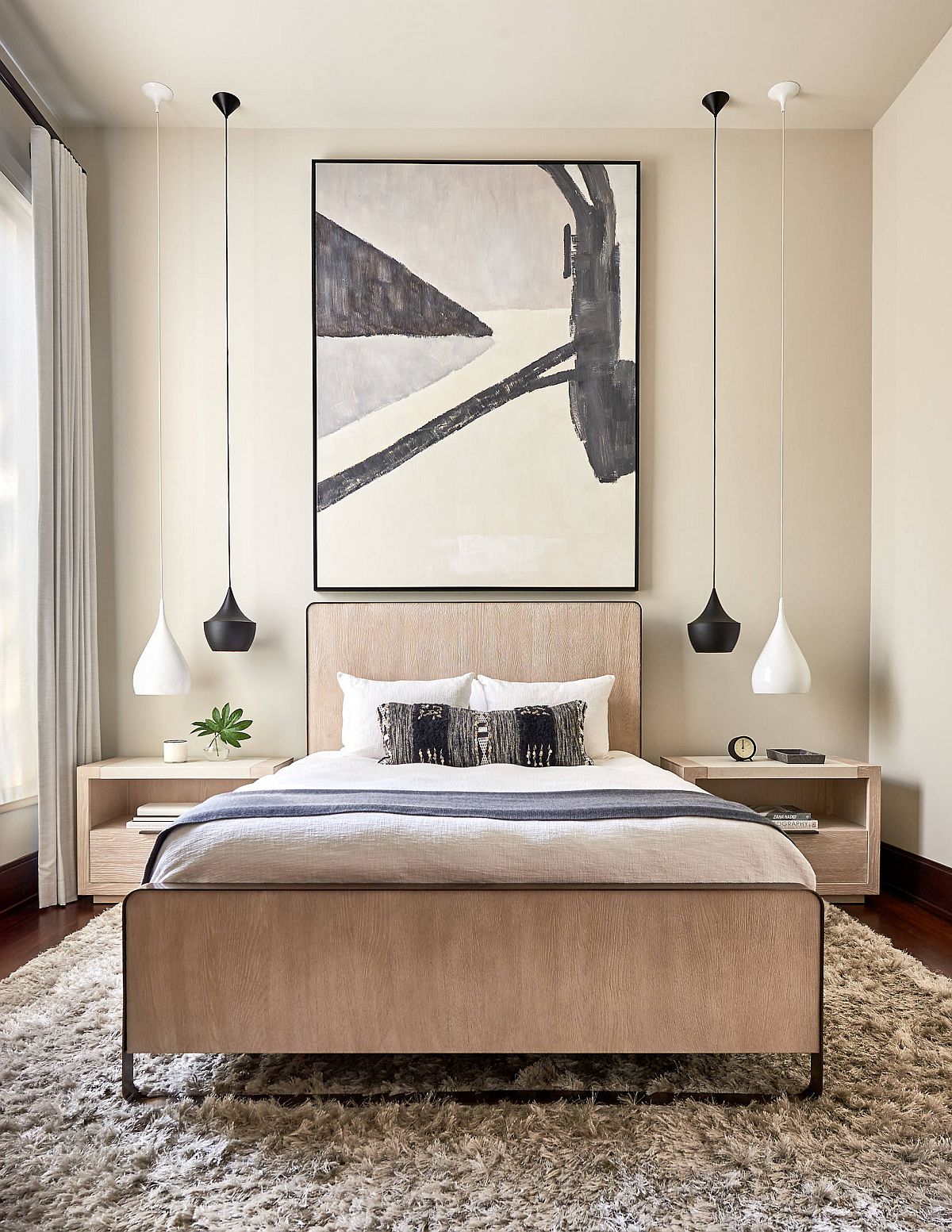 Black and white Tom Dixon pendant lights are used elegantly in this contemporary bedroom