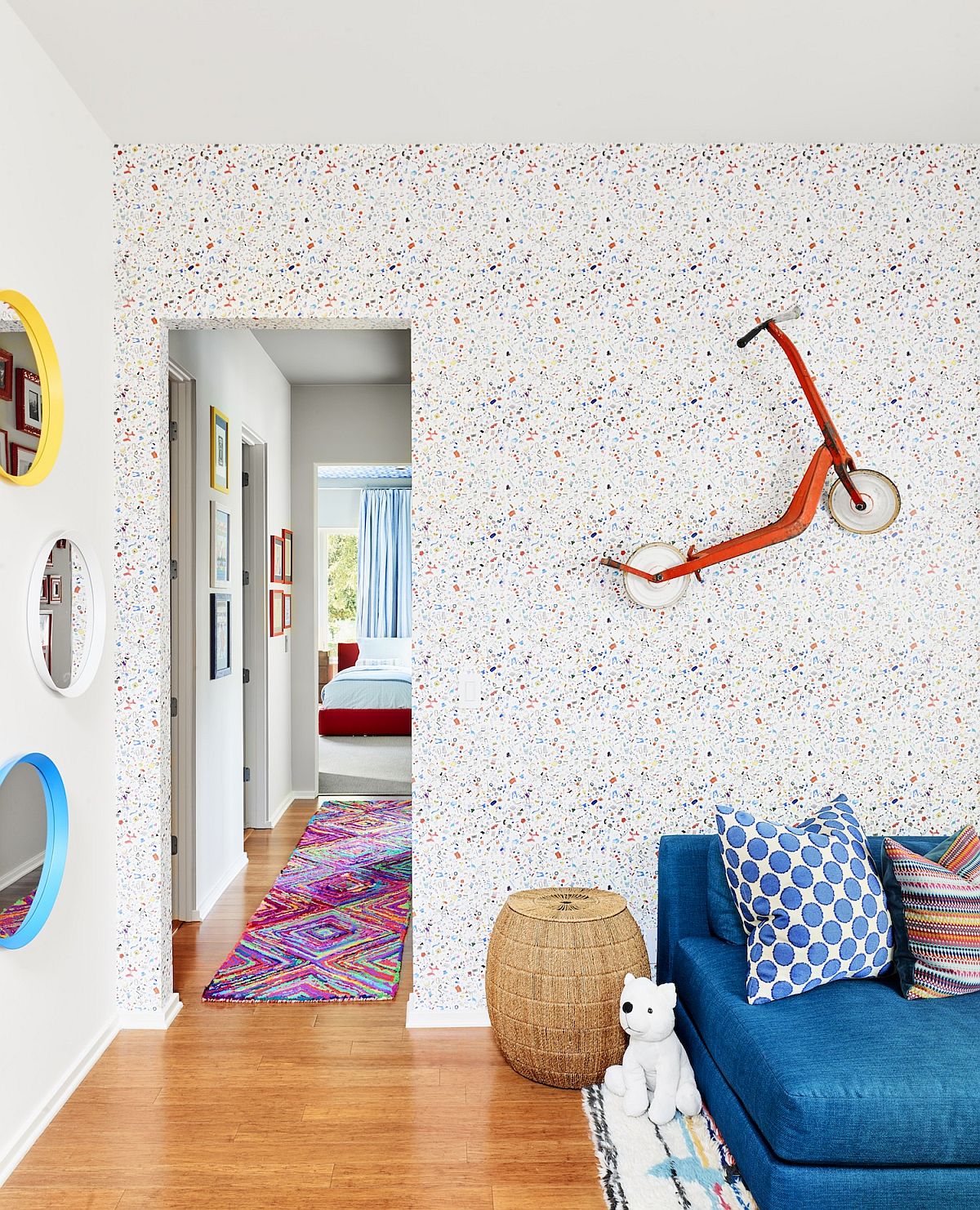 Custom wallpaper and little scooter on the wall bring eclectic charm to this lovely little room