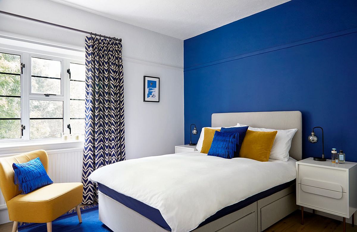 Delightful blend of blue and yellow accents in the modern bedroom with a white backdrop