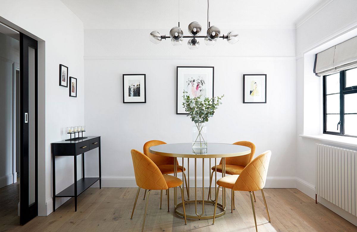 Delightful modern dining room with round white and gold dining table and four yellow chairs