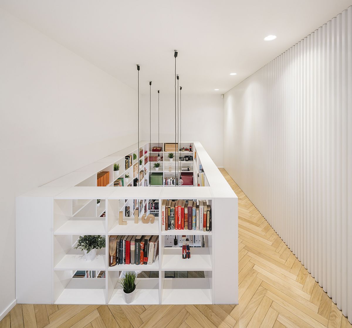 Dramatic bookshelves become a part of both the lower and upper levels of the house