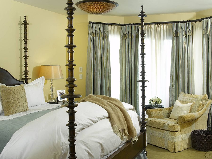 Drapes and bedding are used to add gray to this bedroom in yellow