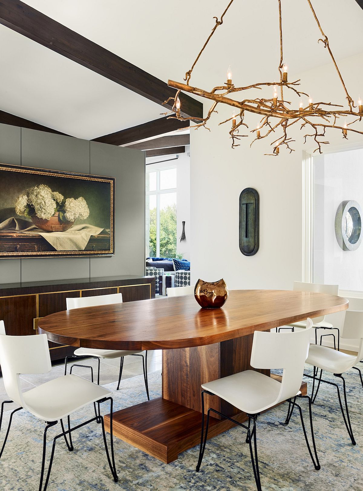 Fabulous custom lighting fixture in the dining room with a large, oval wooden table