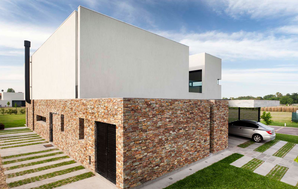 Facade of the House A in Buenos Aires, Argenine with a stone wall that offers ample protection