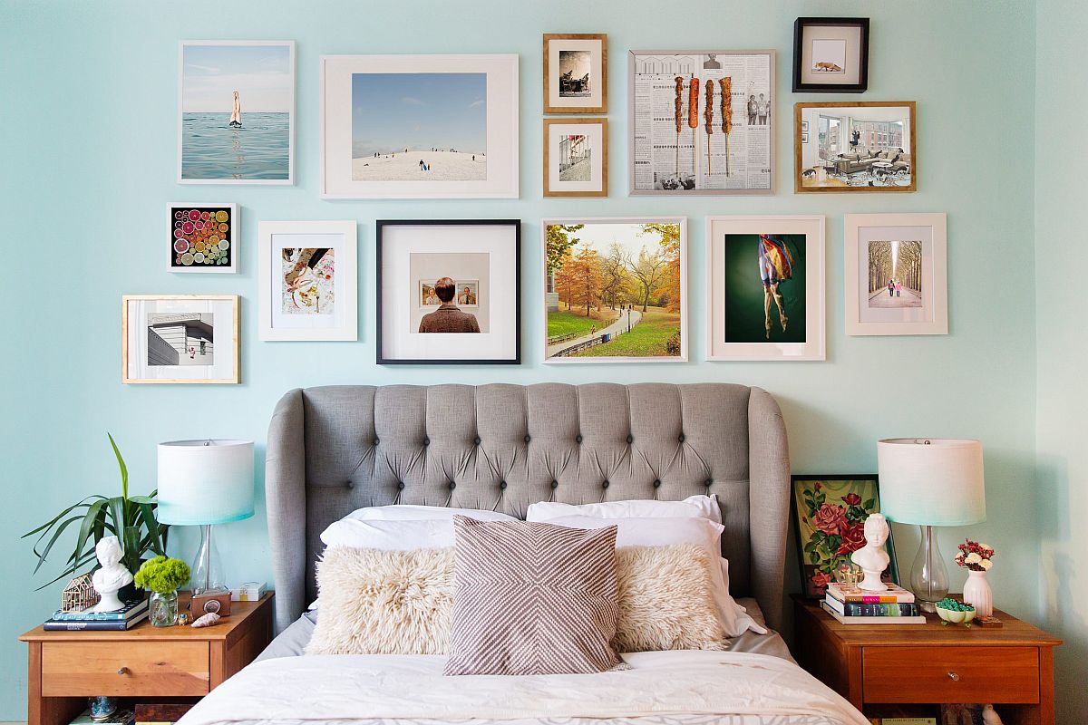 Headboard gallery wall steals the spotlight in this modest modern bedroom in blue