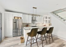 Kitchen-of-the-renovated-townhouse-in-white-with-wooden-floor-and-stone-backsplash-74543-217x155