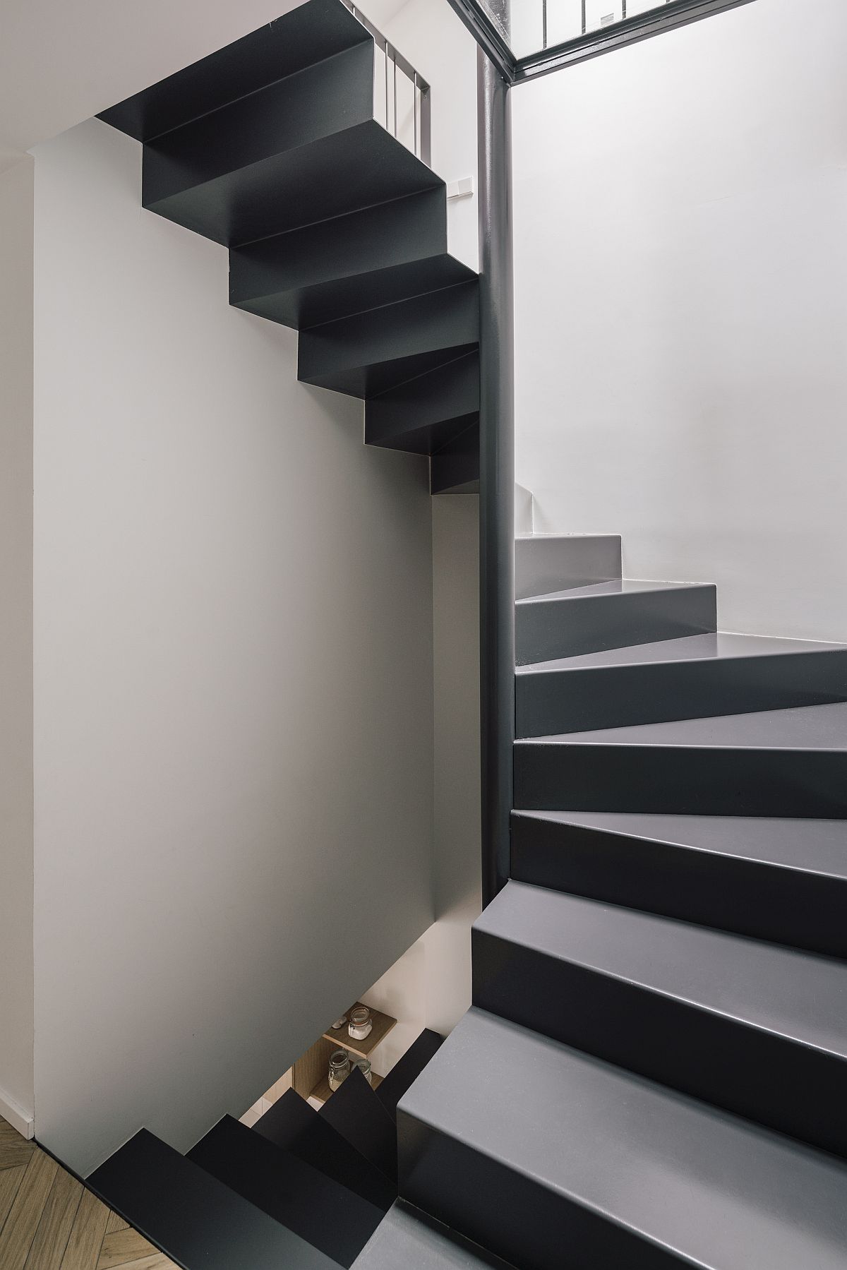 Lovely and space-savvy staircase in gray and white connects the variors levels inside the house