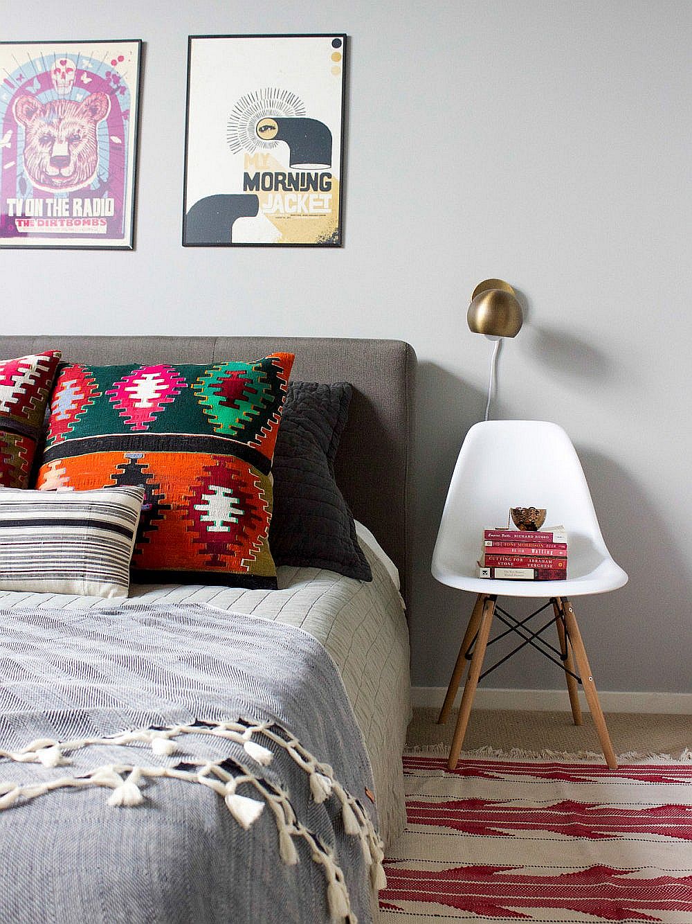 Lovely balance of colors in the bedroom is accentuated by the use of white bedside chair