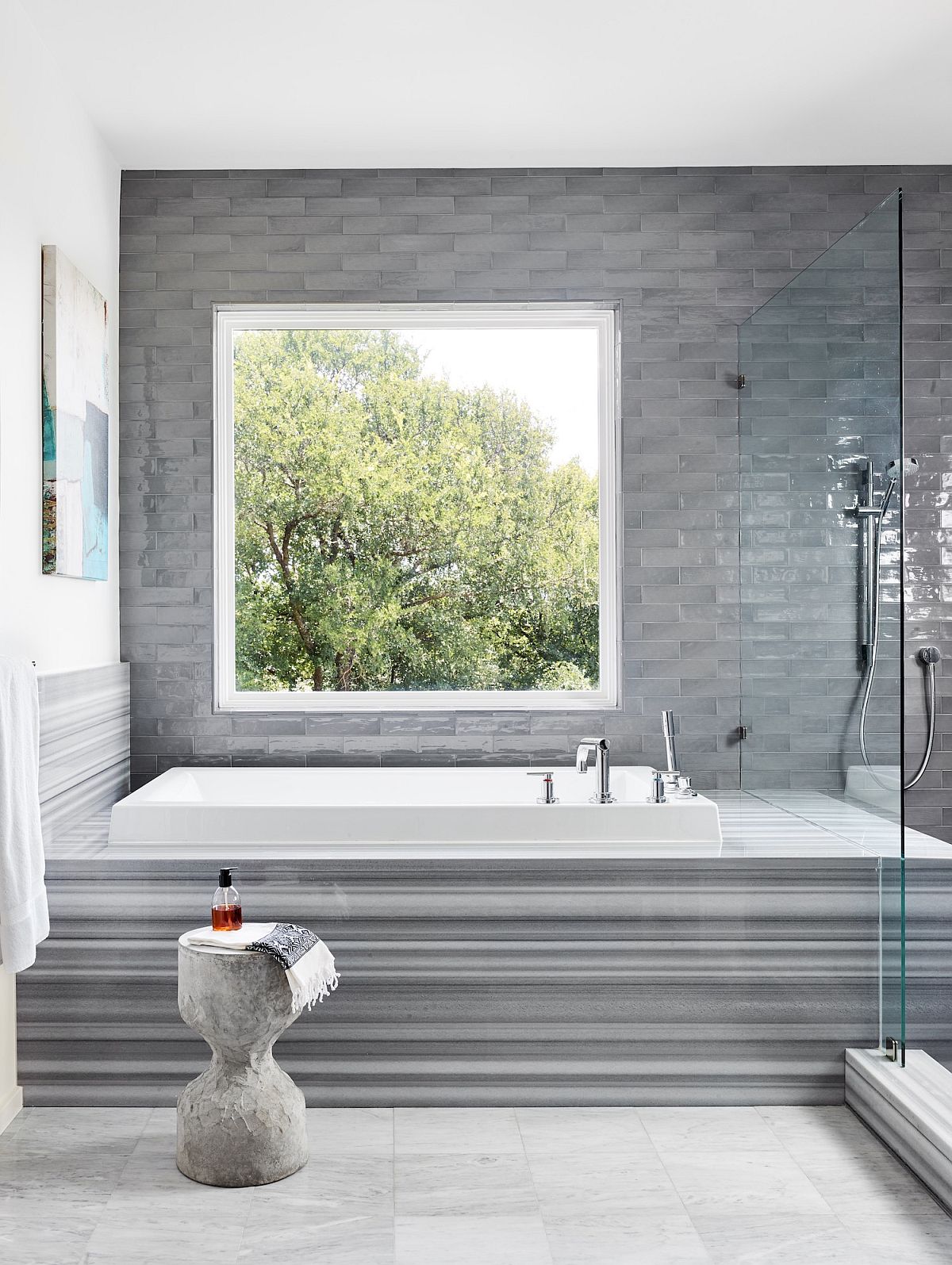 Master bathroom in white with gray tiles that create a lovely background and bathtub