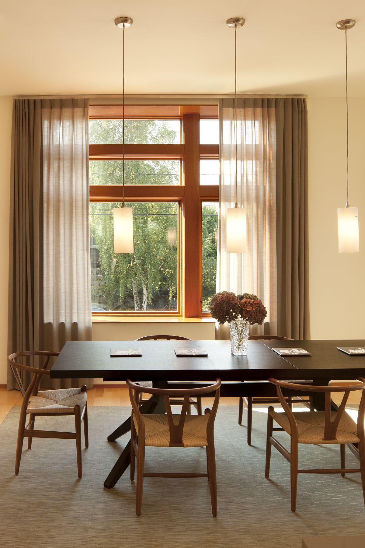 Modern-formal-dining-area-in-beige-with-lovely-drapes-and-trio-of-pendant-lights-41073