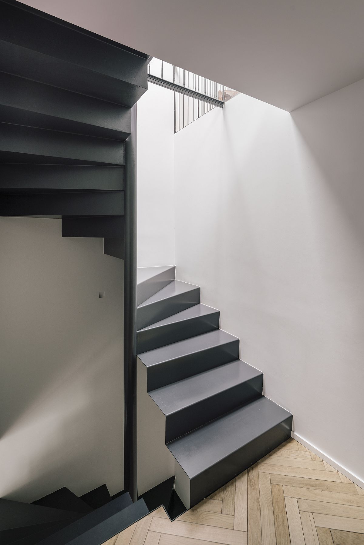 Natural light illuminates the staircase and different levels inside the house