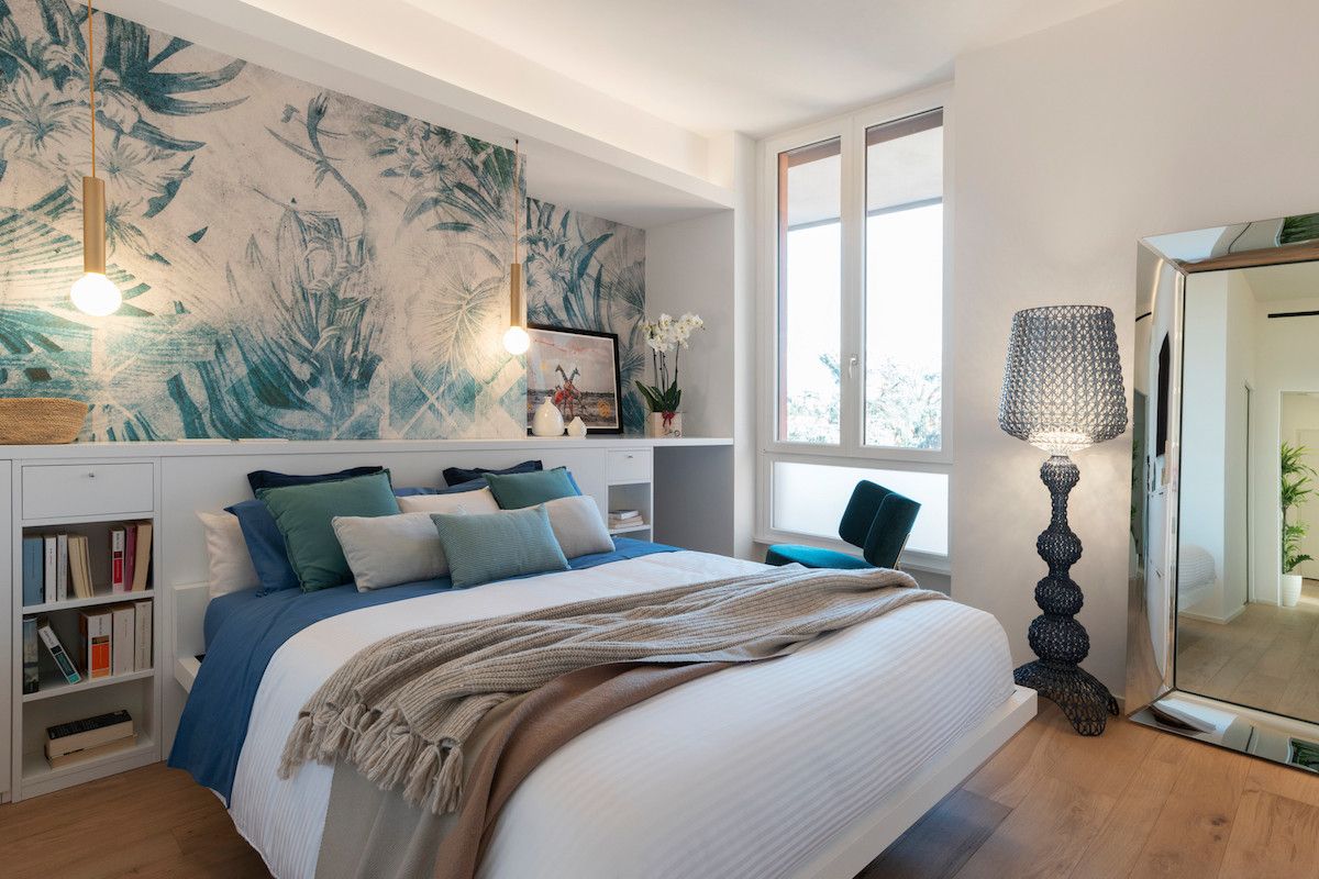 Relaxing beach style coupled with pops of blue and green in the bedroom