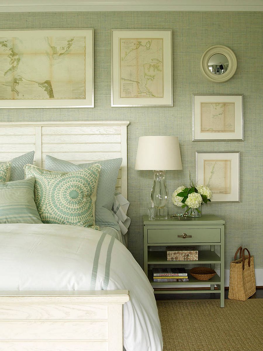 Relaxing bedroom in pastel green and white with a gallery wall that adds to its charming appeal