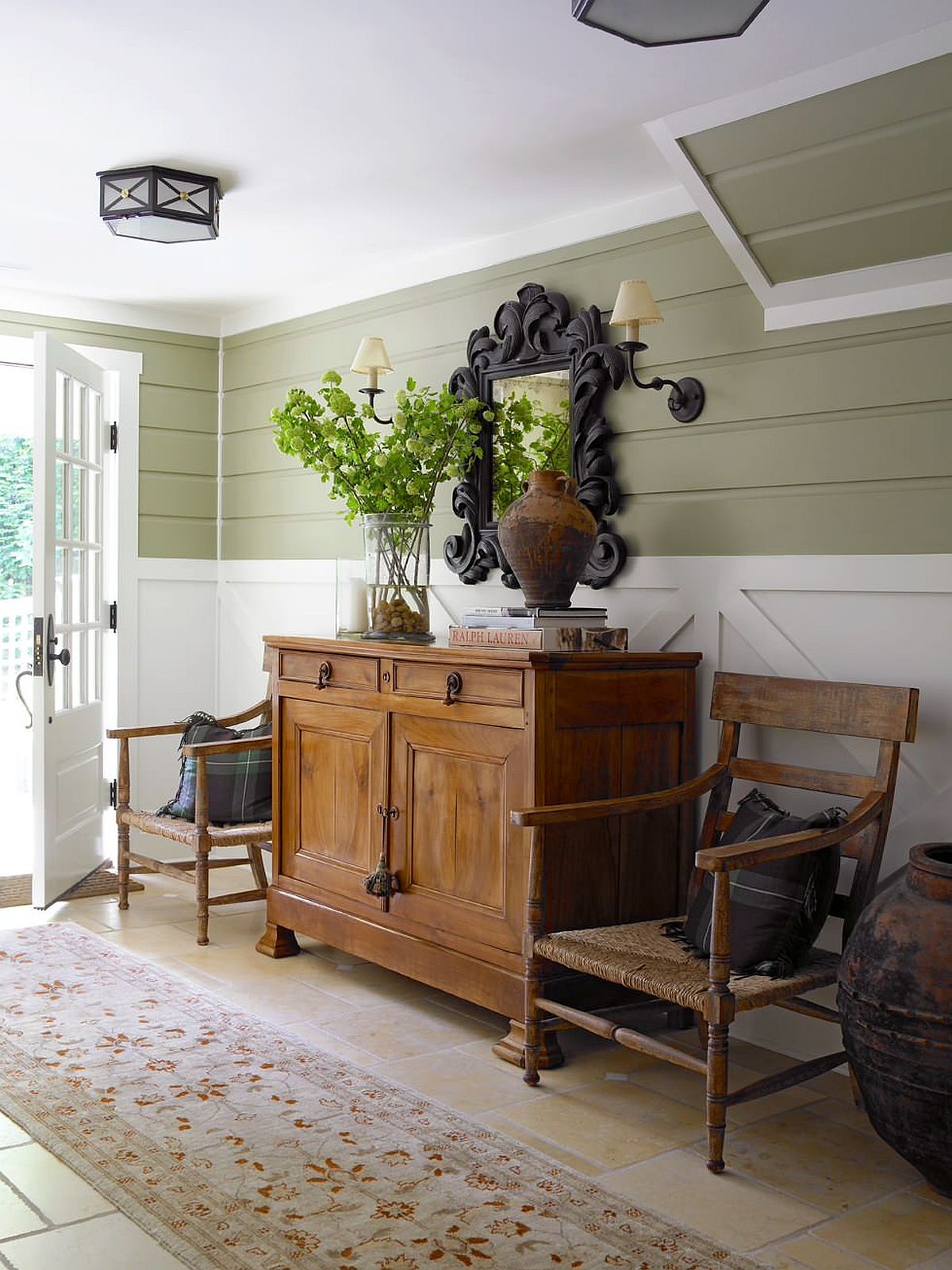 Snazzy white and green entryway feels welcoming despite its low roof