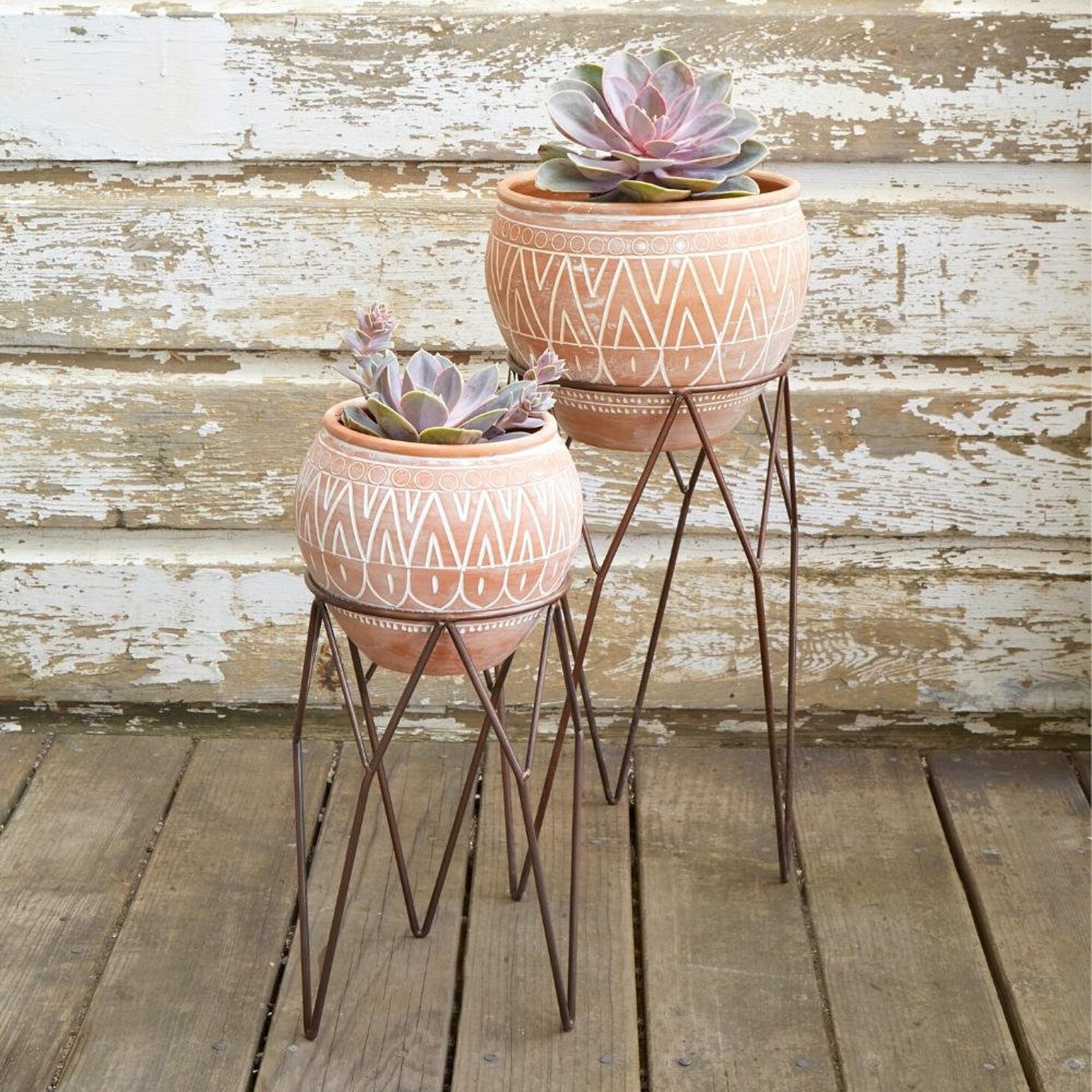 Terracotta pots with metal stands