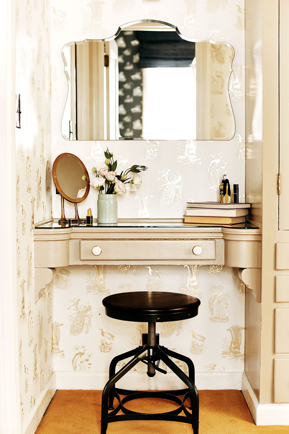 Vanity area with gilded wallpaper