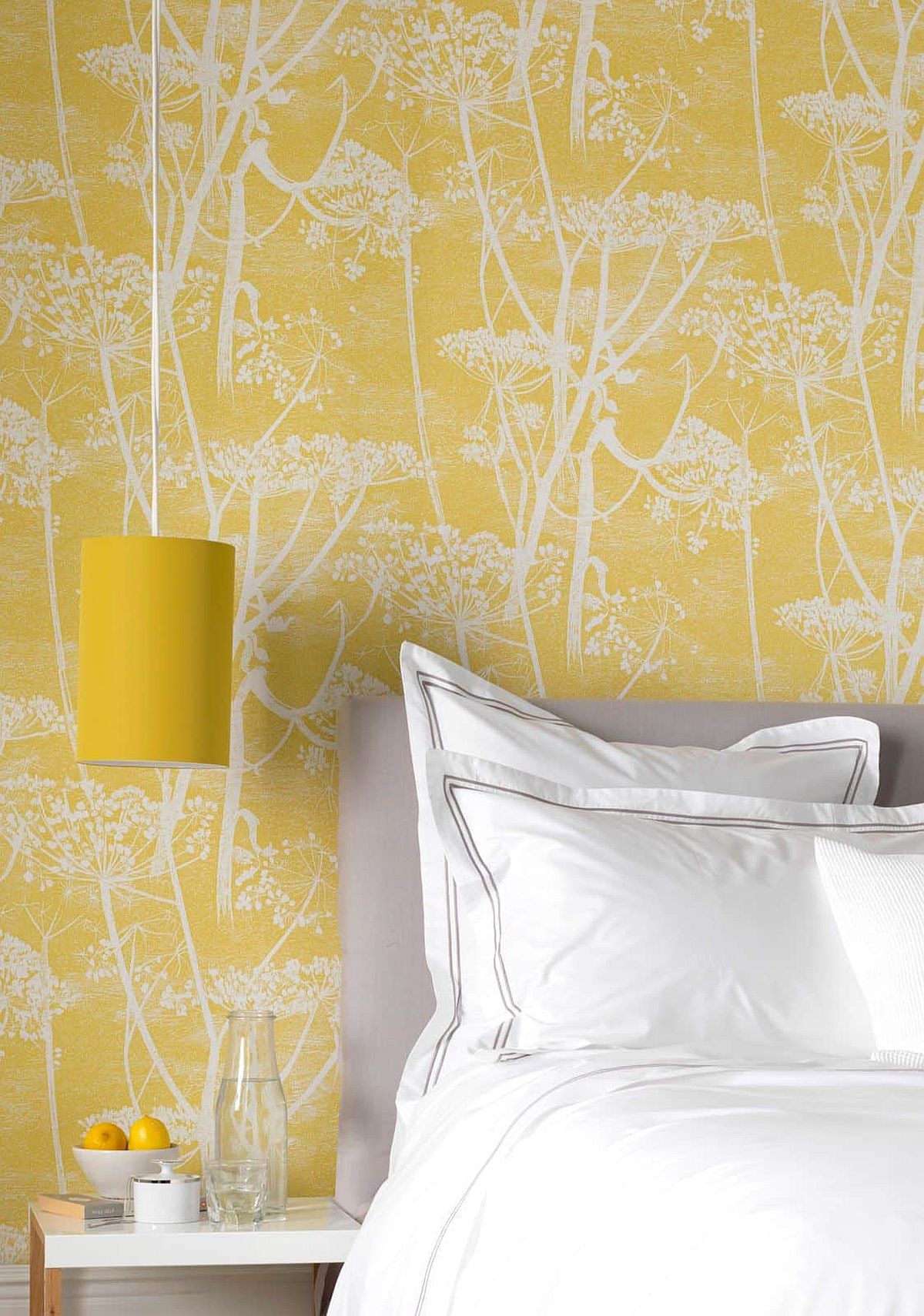 Wallpaper brings yellow to the bedroom by create a cost-effective and colorful accent wall