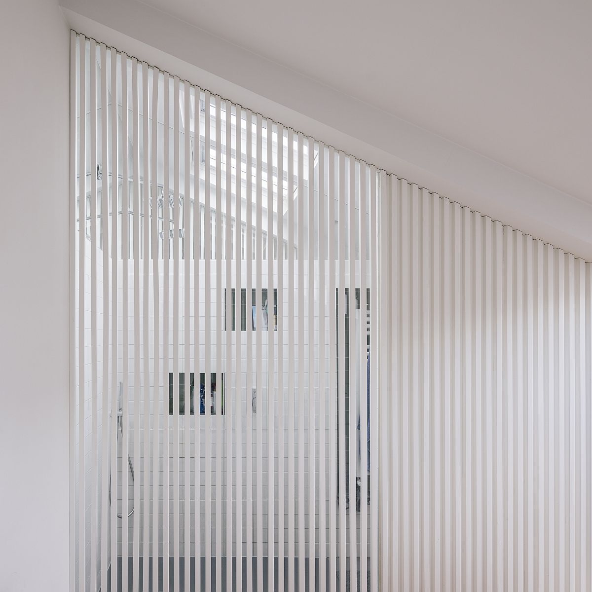 White slats bring light into the shower area