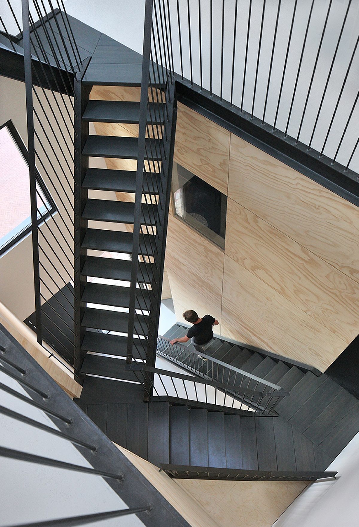 Atrium with vertical walkway styled stairway steals the spotlight inside the Dutch home
