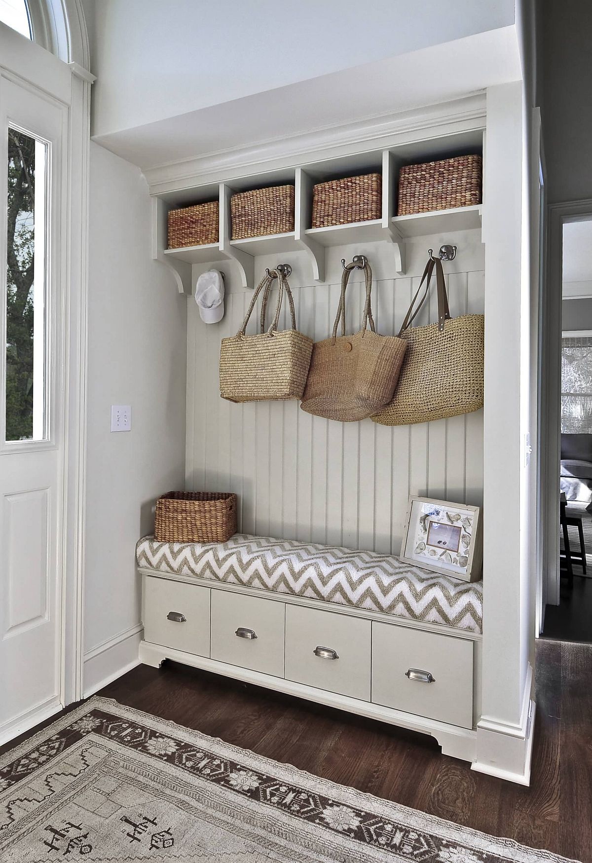 Baskets on the upper level along with cubbies create ample space in this mudroom