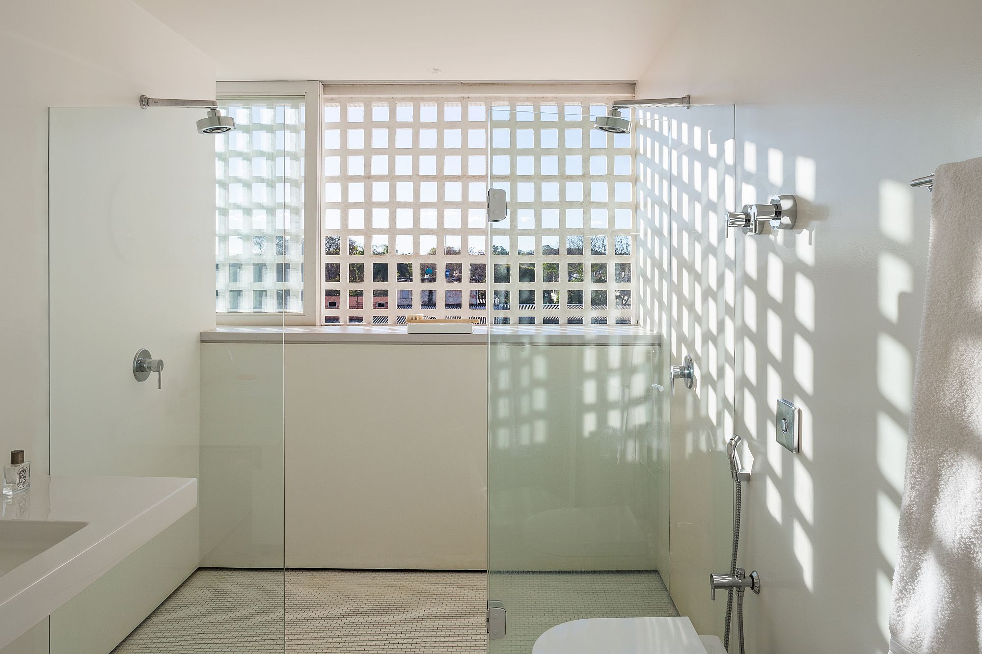 Bathroom in white with ample natural light and glass shower zone