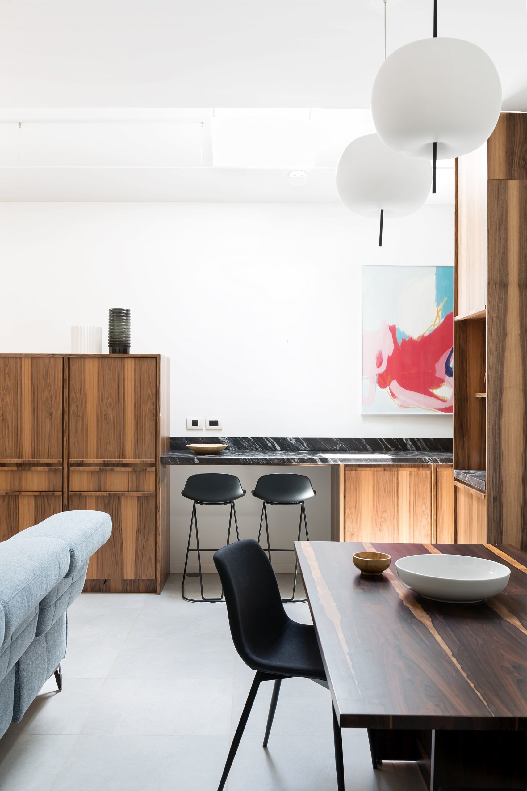 Bespoke wood dining table next to the kitchen feels like an extension of the carpentry