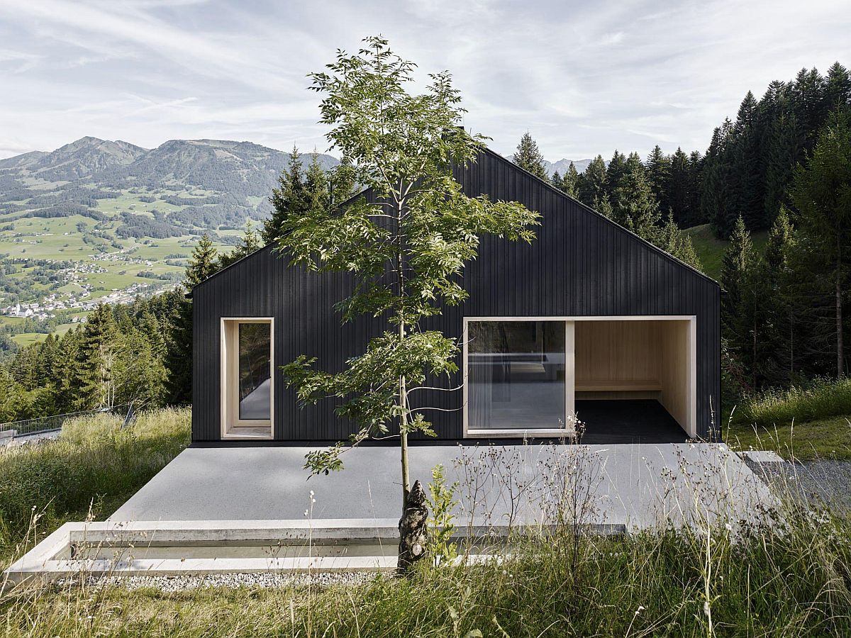 Black wood exterior of the holiday house gives it a modern and unique visual appeal.