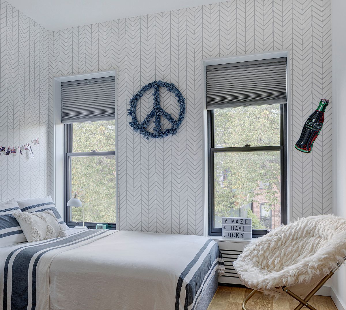 Blue and white teen bedroom that is gender neutral features pattern-filled walls