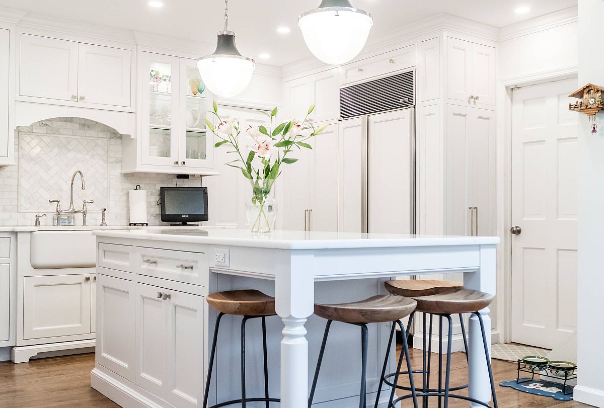 Blue block of the kitchen island is the only color you find in this white transitional style kitchen