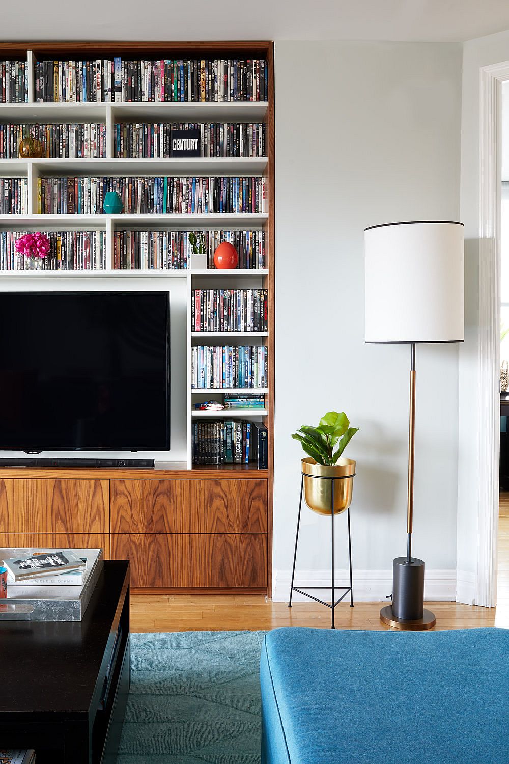 Bookshelf and TV space in the living room of the NYC home become the focal point