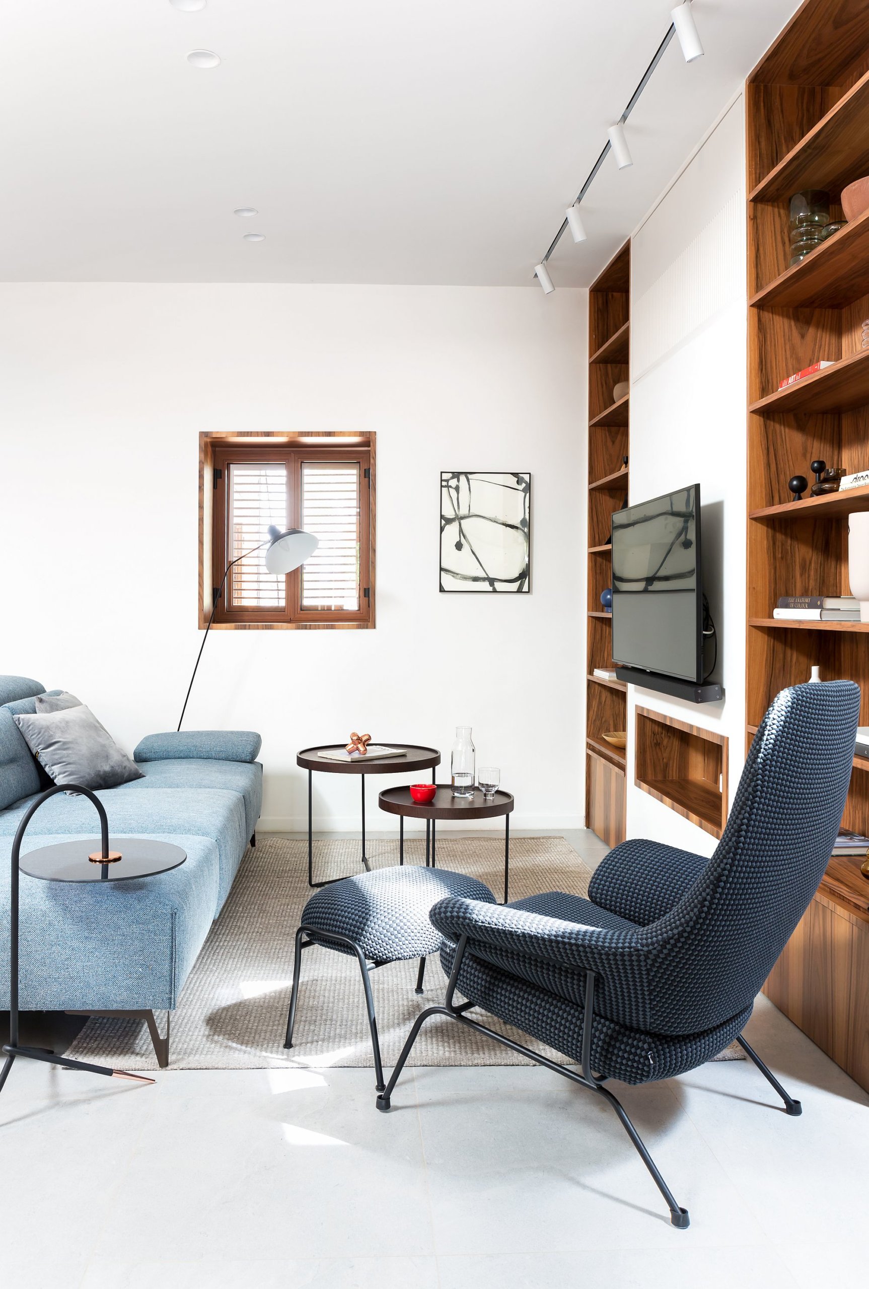 Bright blue couch in the living room brings color to the setting