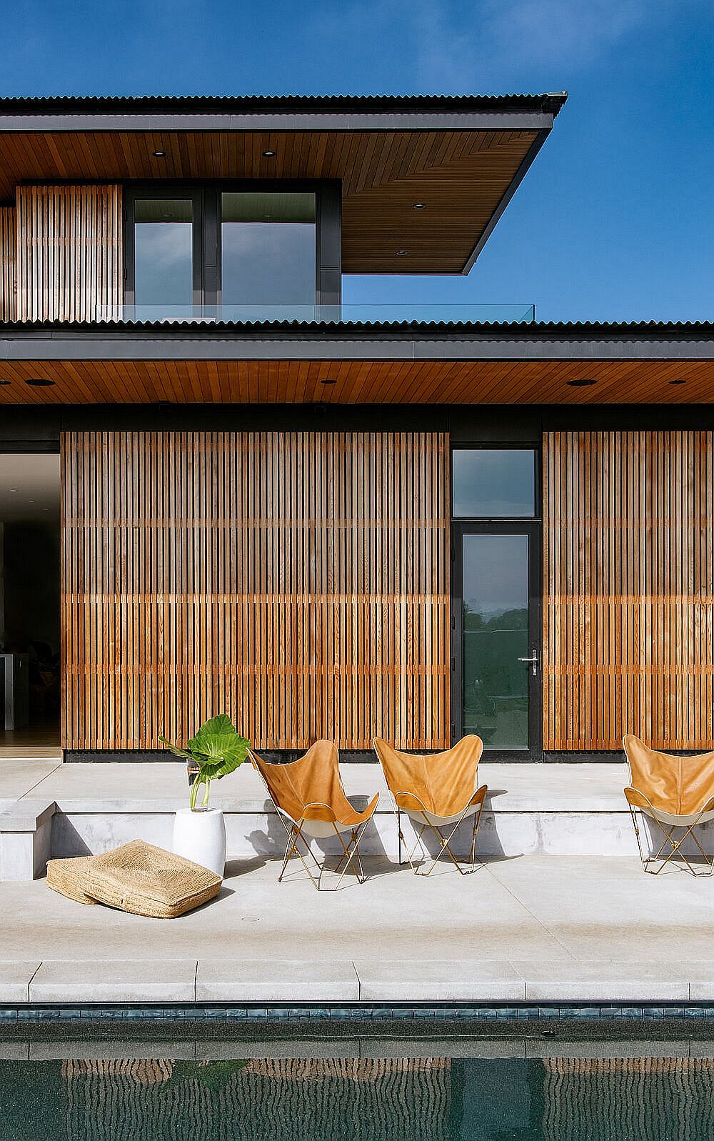 Butterfly chairs on the deck next to the pool offers a relaxing spot to enjoy the views outside