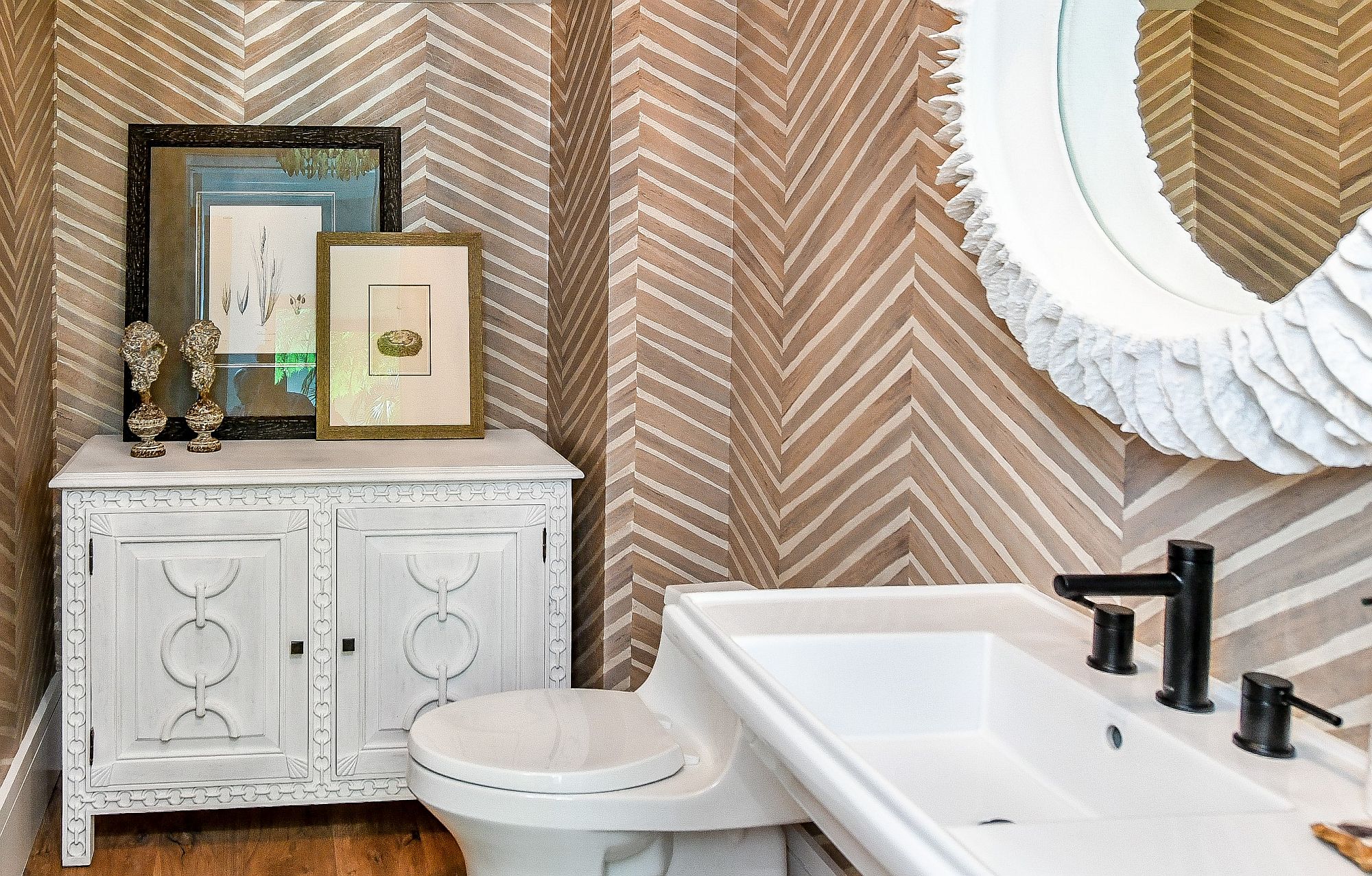 Chevron pattern on the walls makes the biggest impact in this small powder room