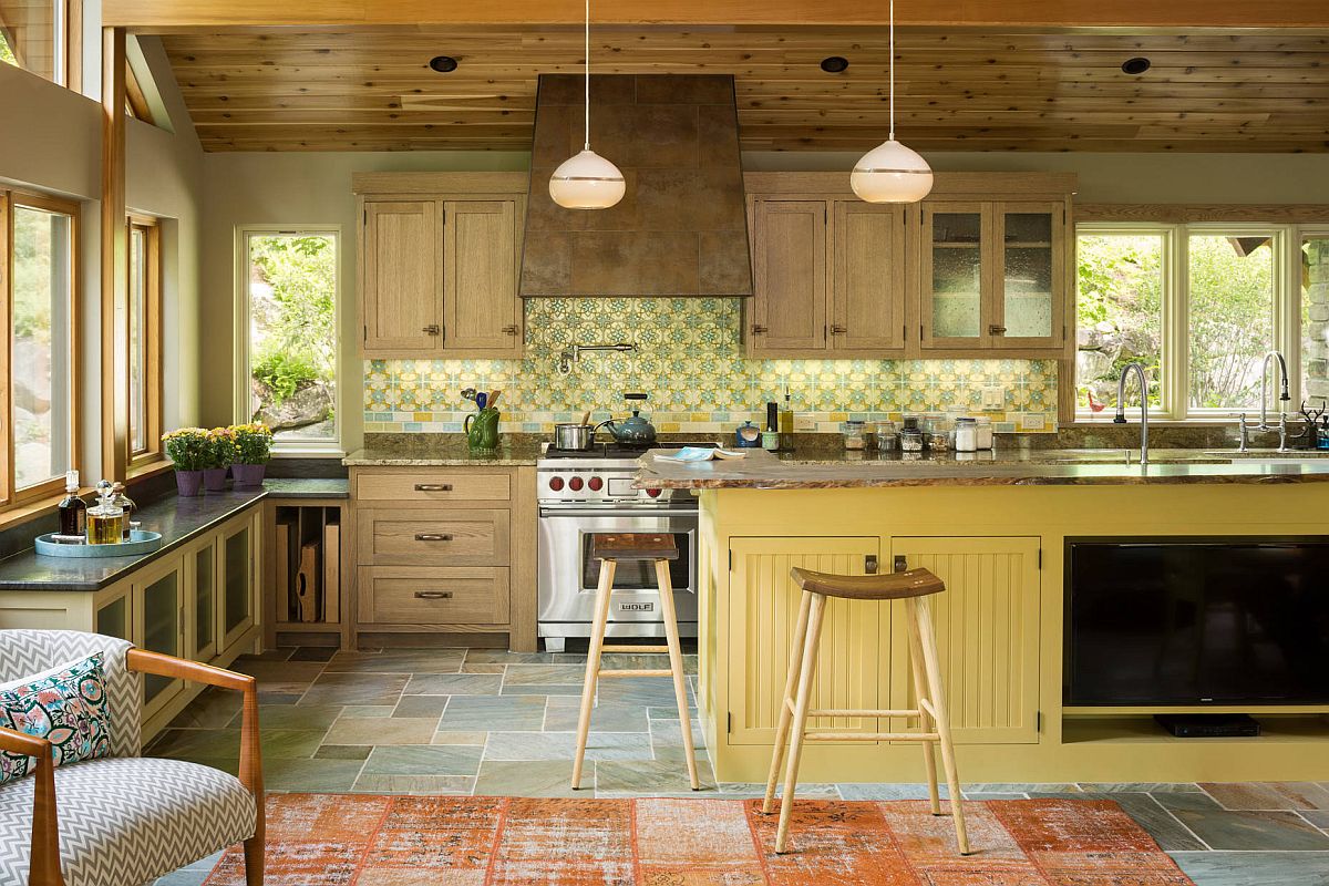 Custom backsplash and floor tiles add different shades of green and yellow in here even as the island steals the spotlight