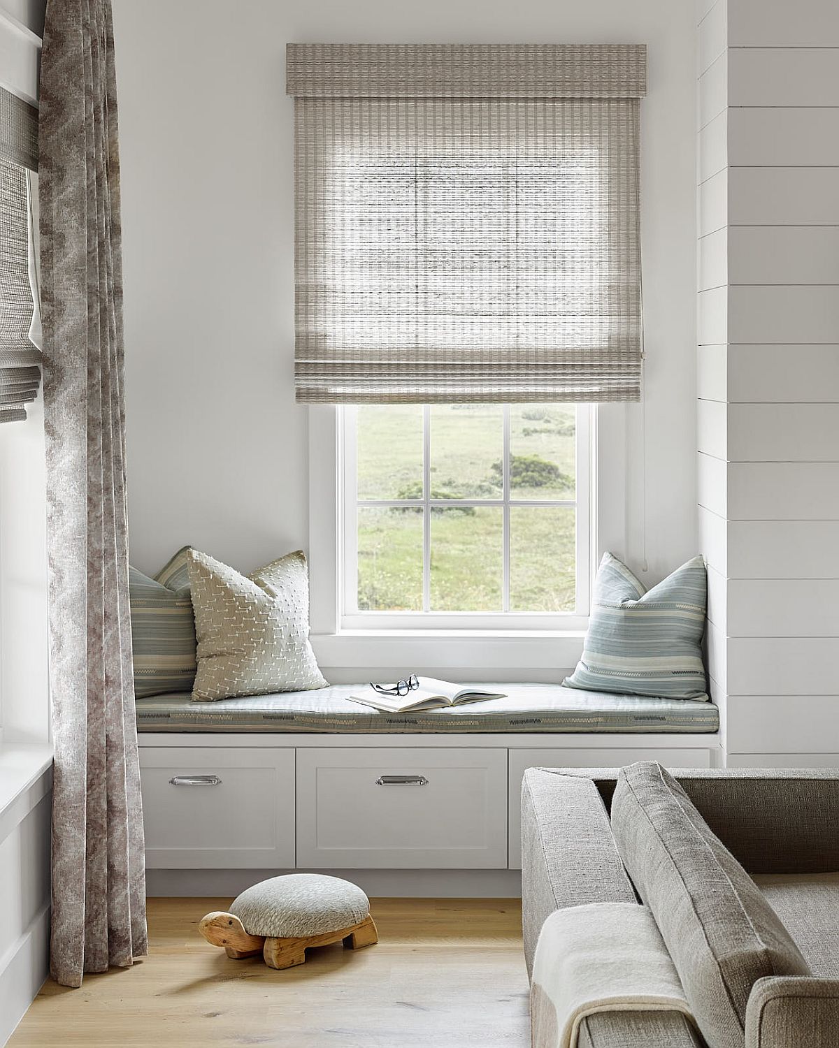 Custom built-in window seat adds to the options in the living room