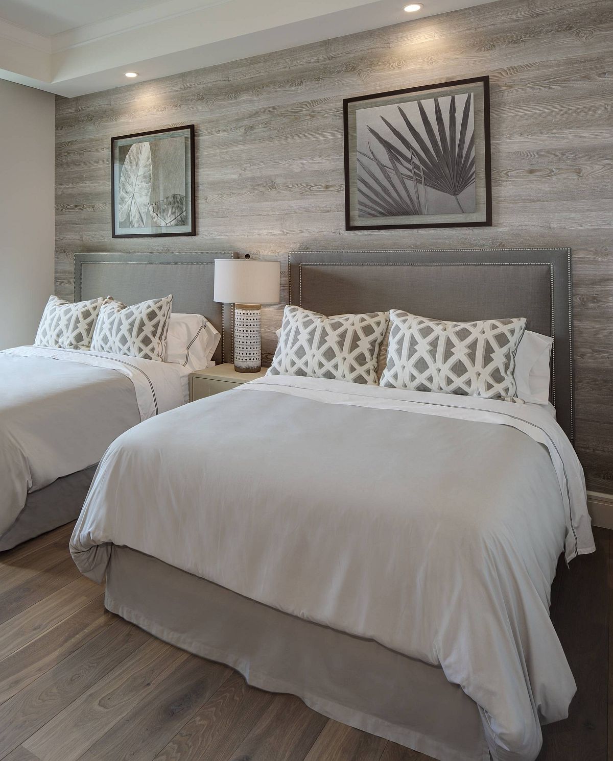 Custom wooden accent wall also brings a shade of gray to the bedroom with light gray walls