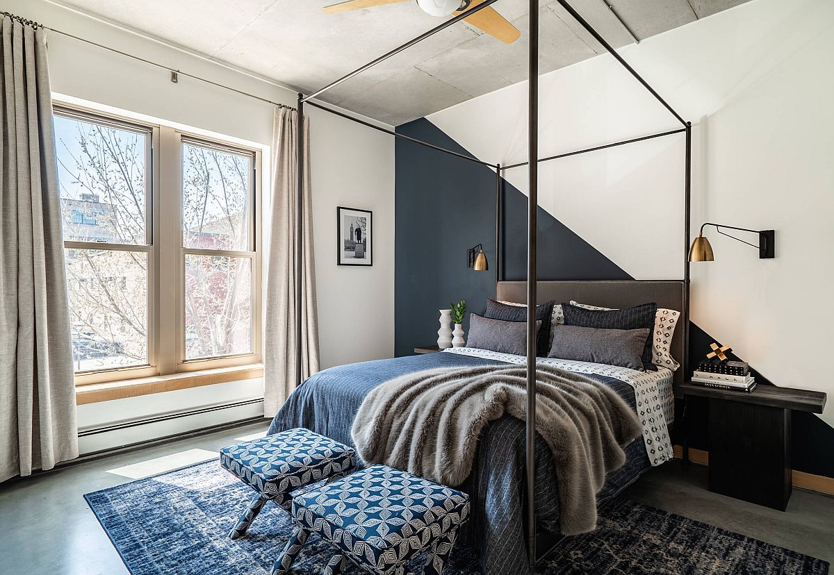 Dark gray and white accent wall in this polished bedroom moves away from the mundane