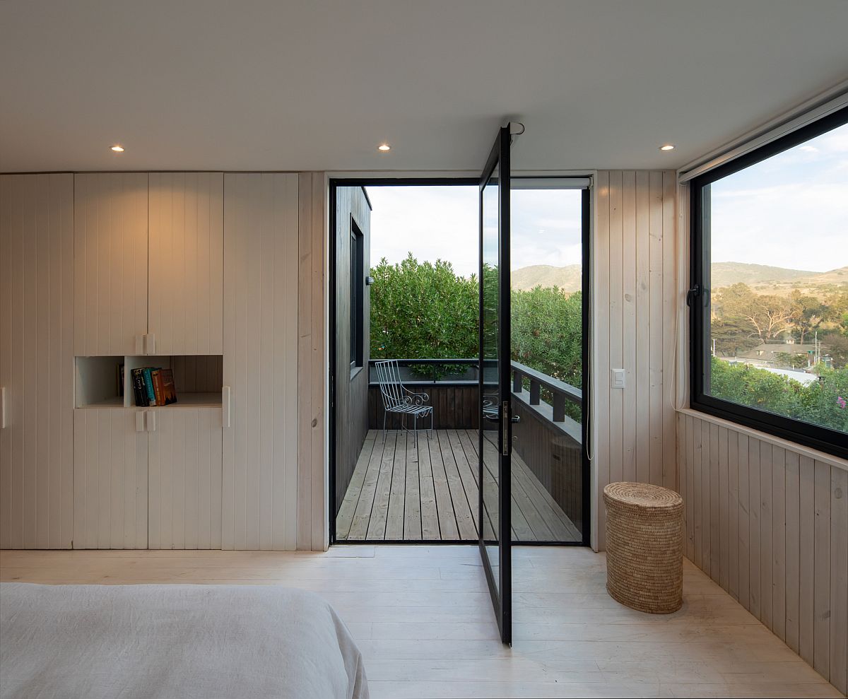 Door pivots open to connect the spaciou balcony with the bedroom on the upper level