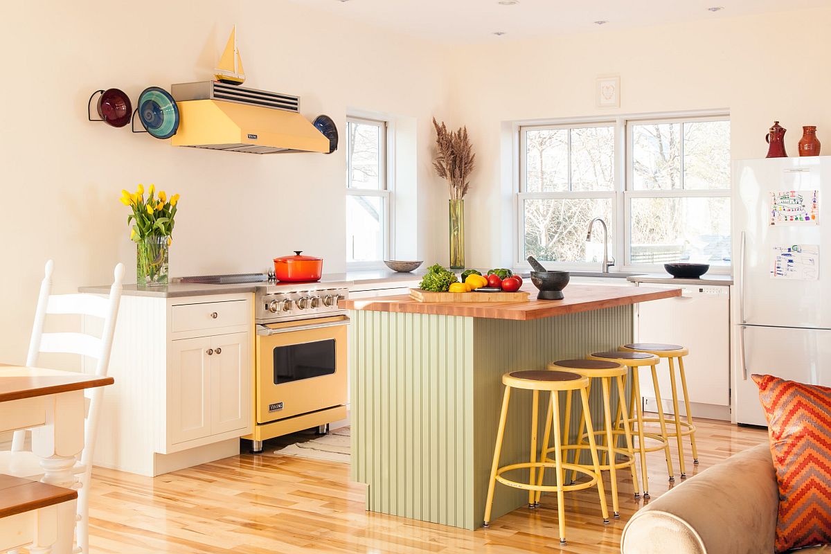 Exquisite eclectic kitchen with a white backdrop and blocks of pastel green and yellow