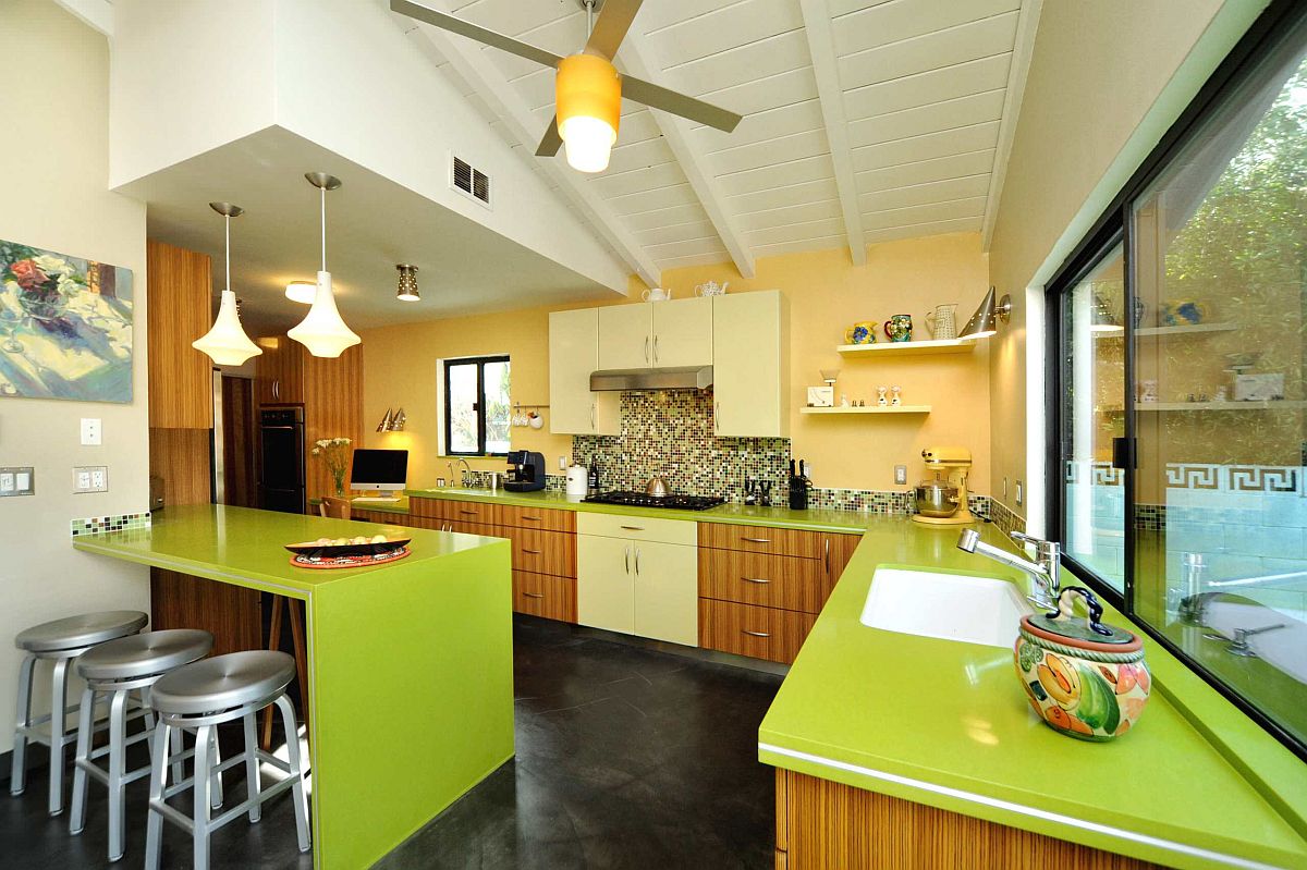 Fabulous mid-century modern kitchen with yellow accent wall and eye-catching green countertops