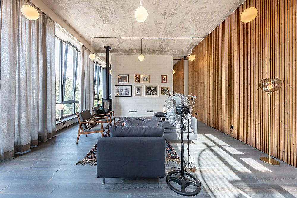 Fabulous wooden wall in the living area and entry brings warmth to the space with concrete and metallic finishes