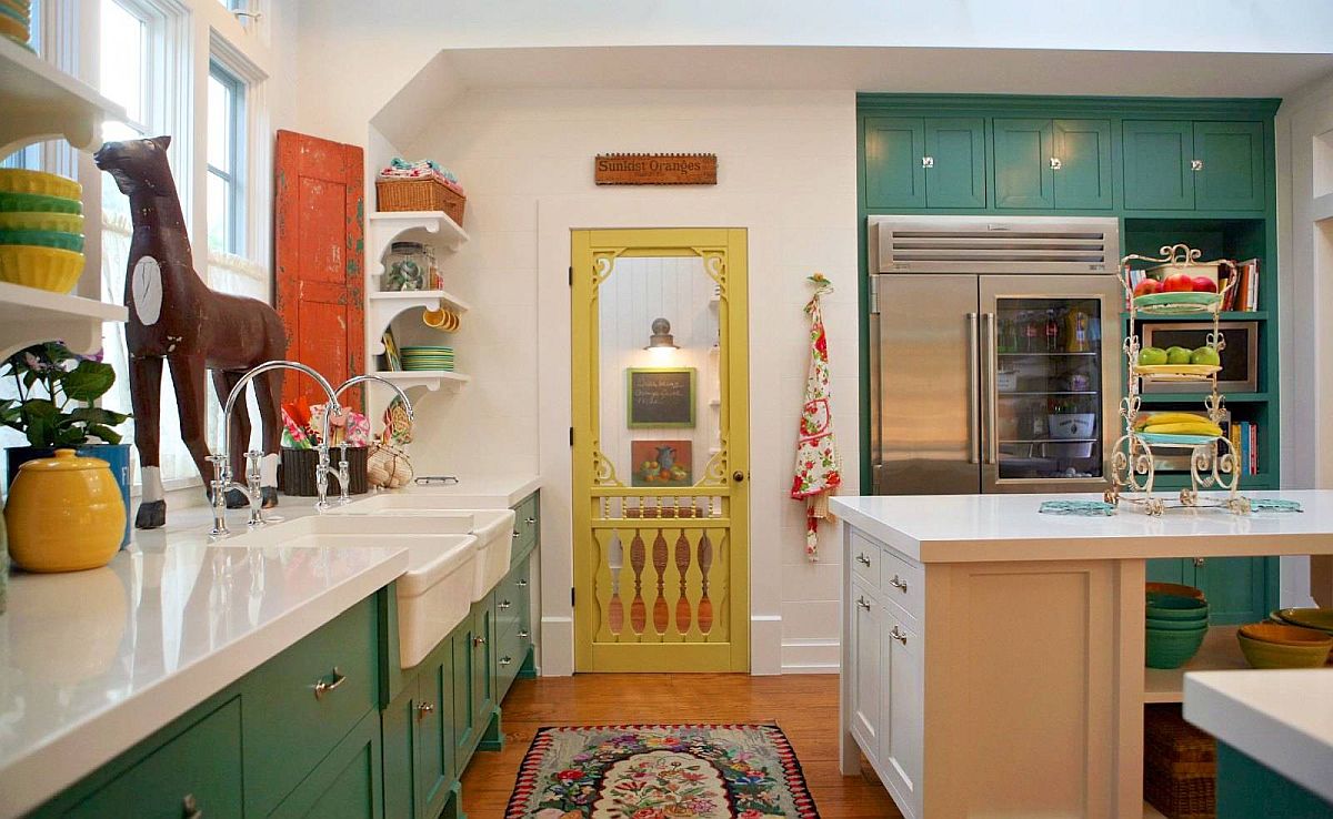 Farmhouse style kitchen with greeen cabinets and a door in yellow along with vintage wooden shutter in the corner