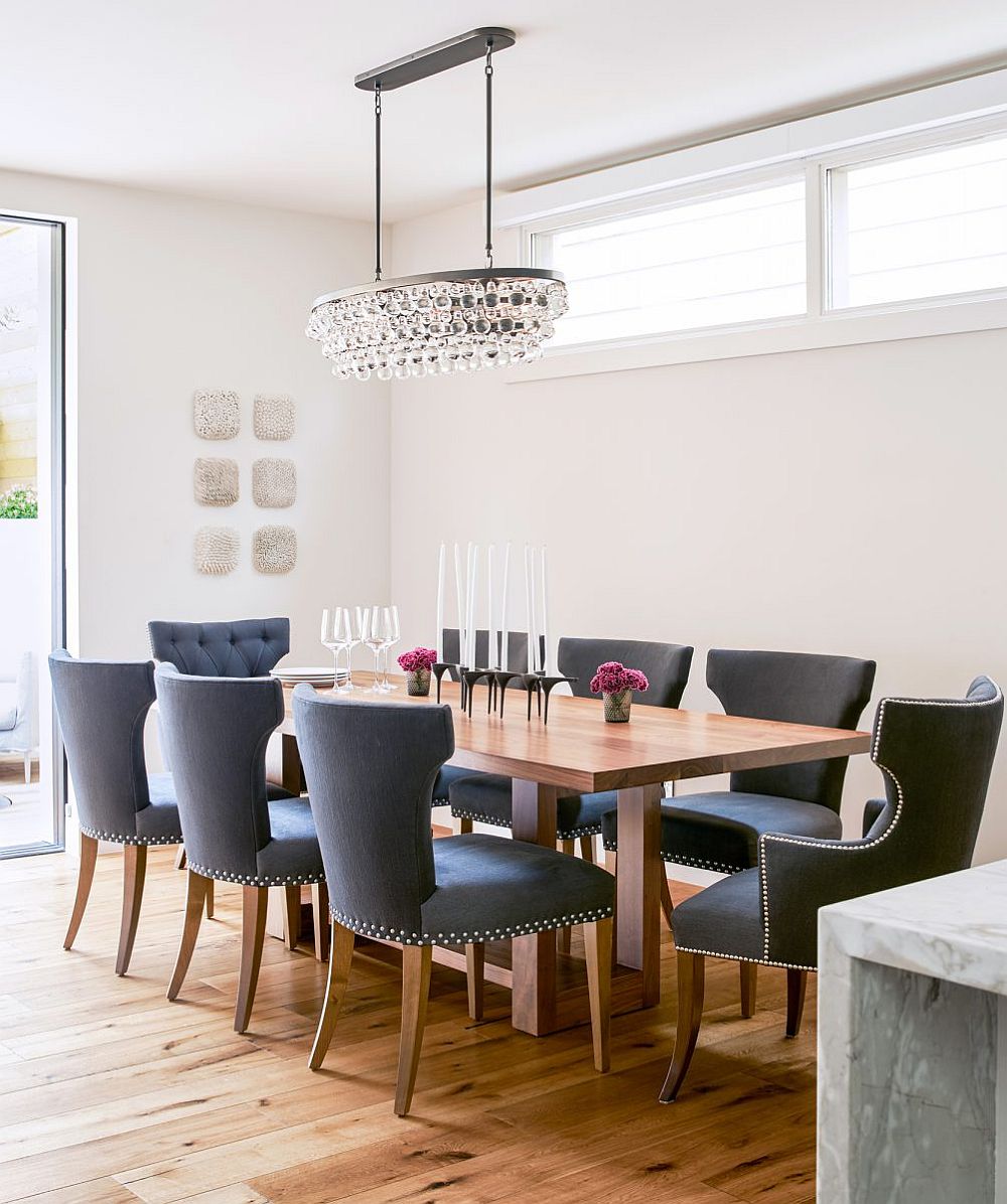 Gorgeous chandelier illuminates the dining area with a relaxed formal look