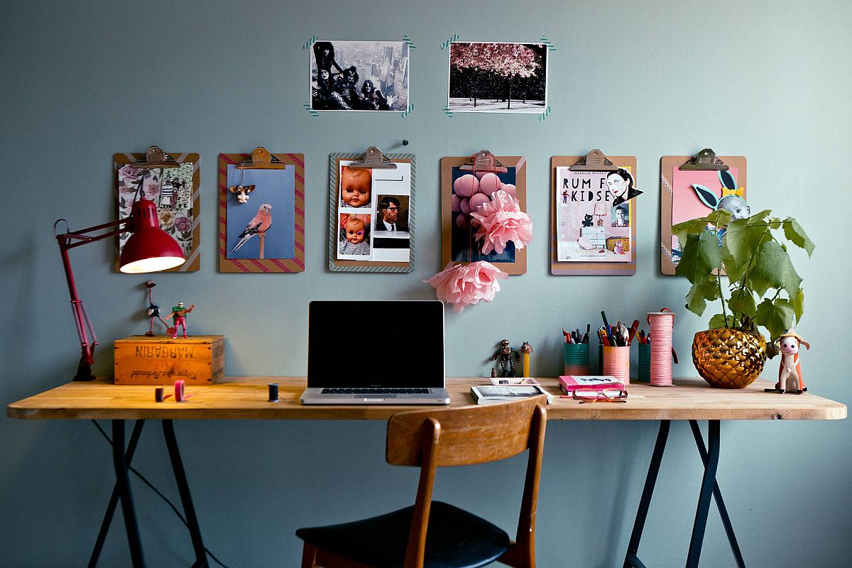 Gorgeous eclectic home office with grayish-blue walls, wall-mounted photographs and clipboards