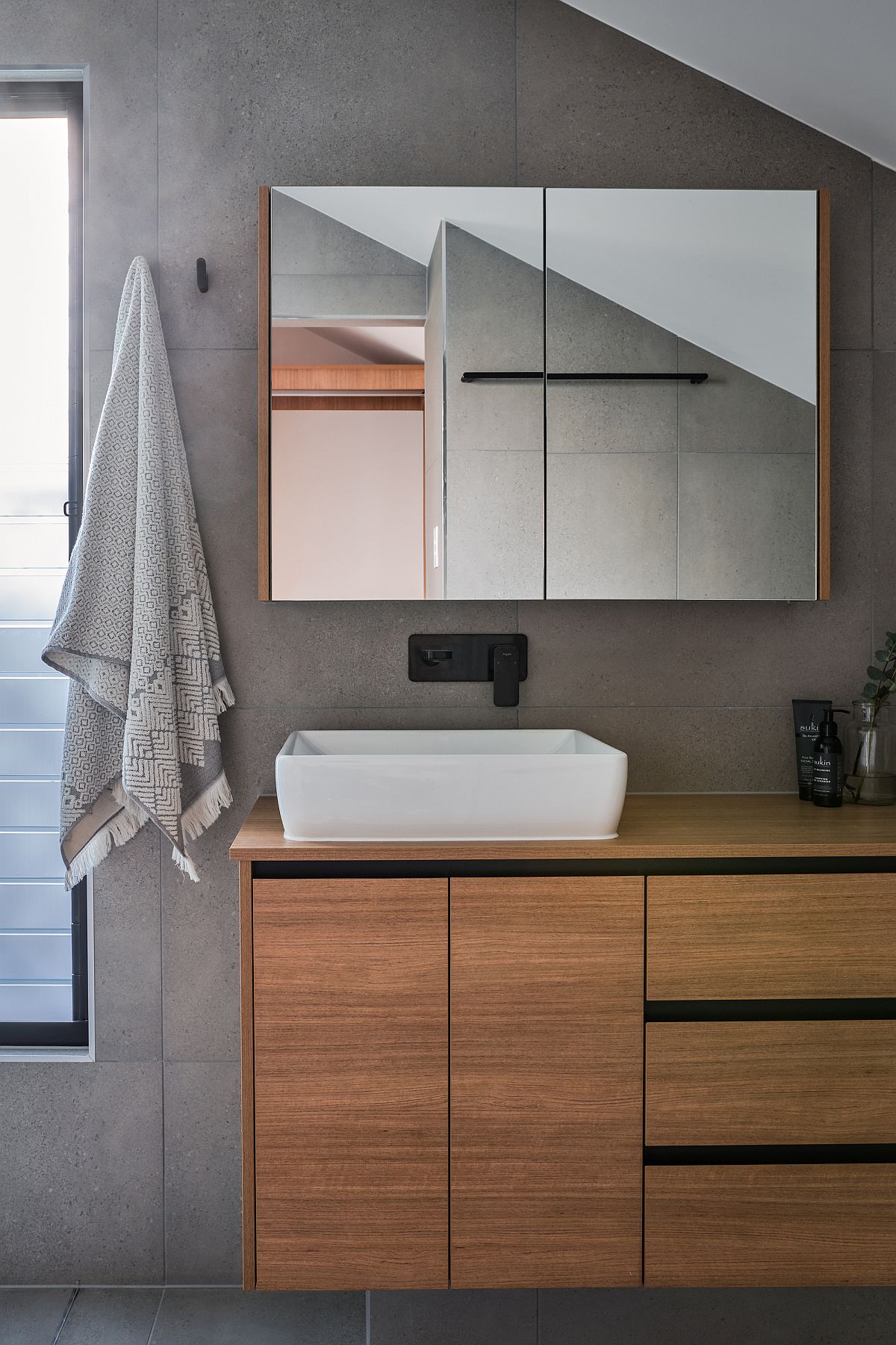 Gray and wood bathroom with an idustrial-minimal style and floating vanity