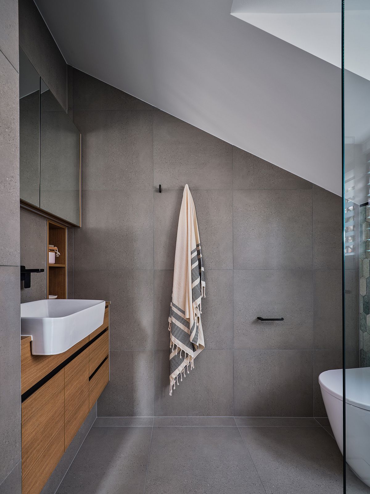 Gray bathroom with floating wooden vanity and white sink