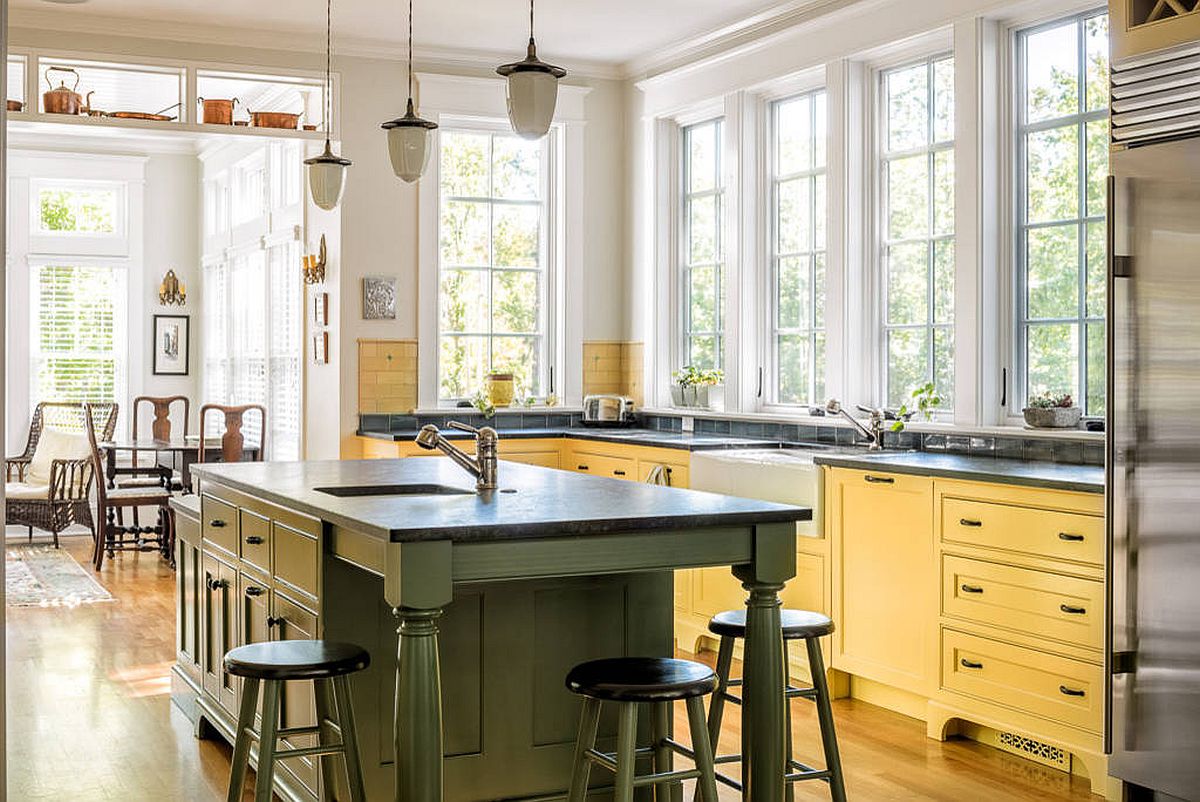 Green and yellow in mellow, matte shades add color to this light-filled traditional kitchen