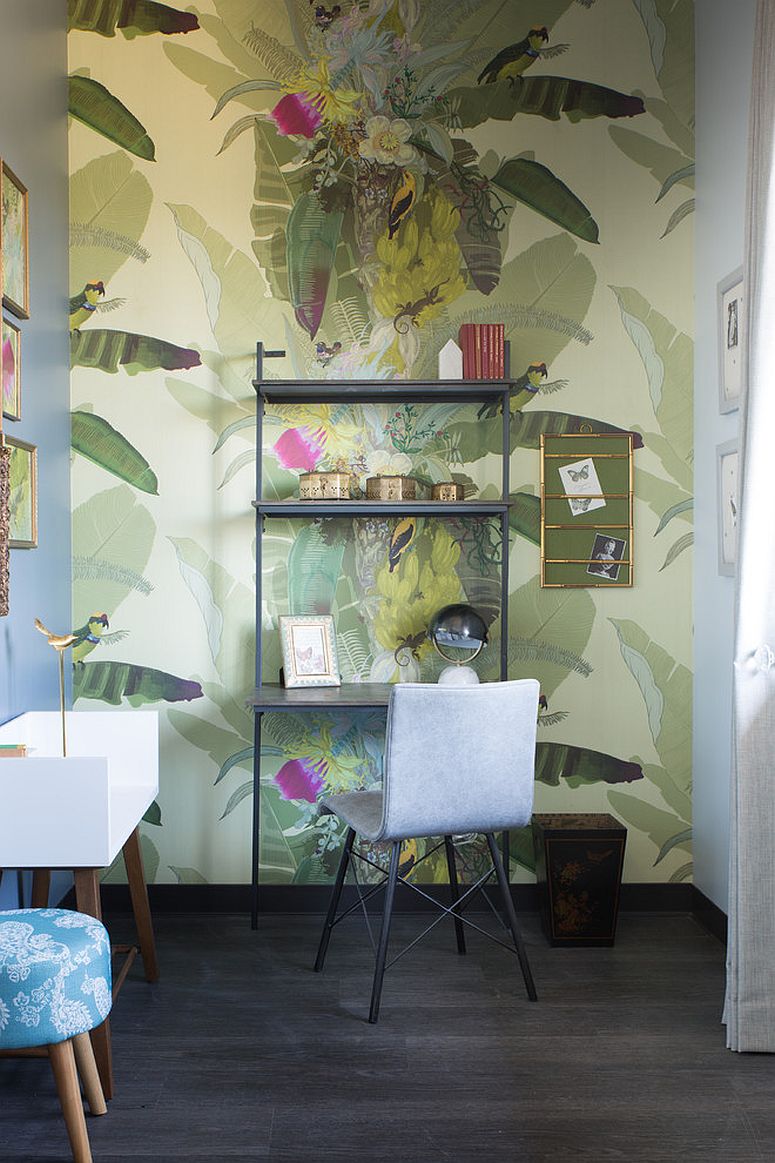 Green, pattern-filled wallpaper gives this eclectic powder room tropical freshness